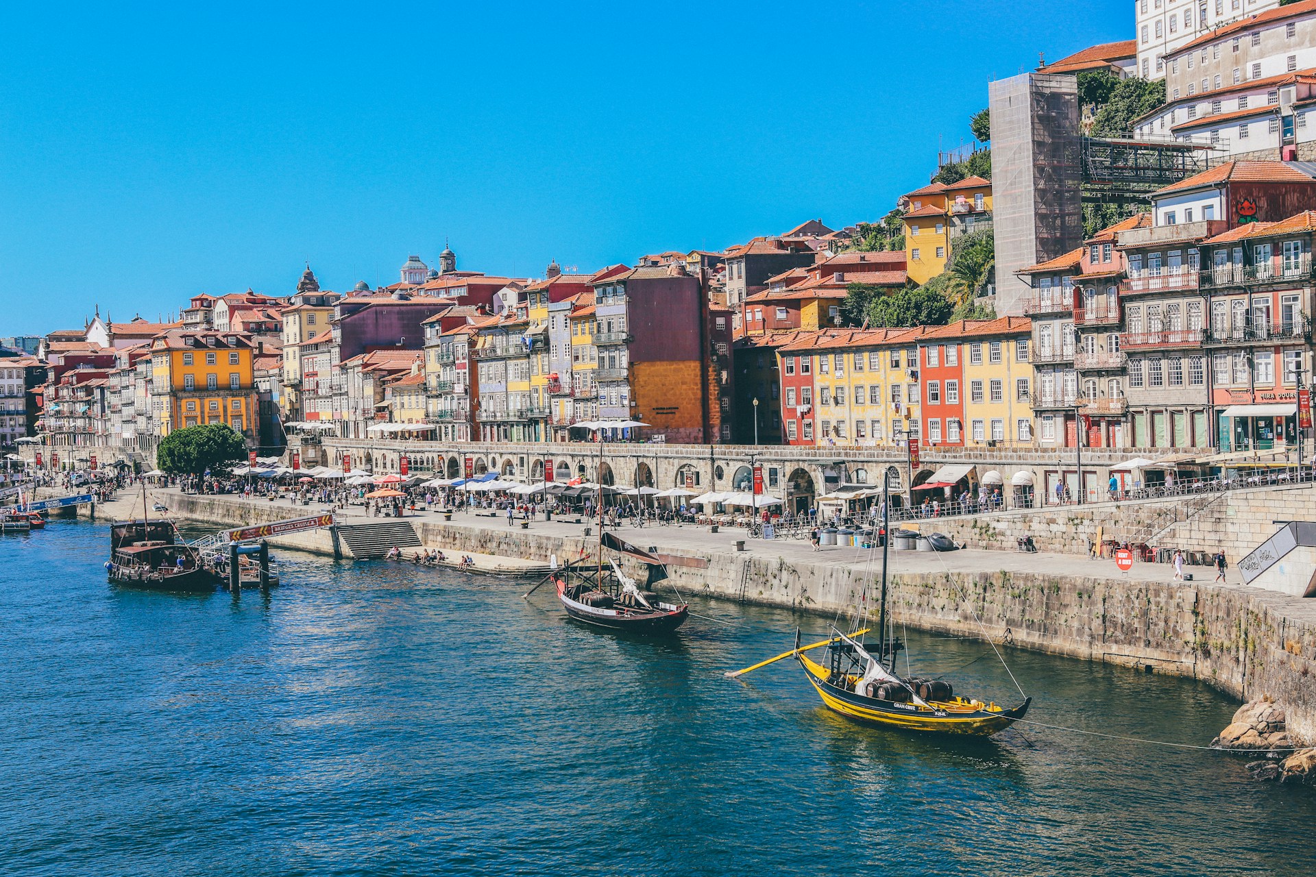Vibrant, multicolored buildings lining the banks of the Douro River in Porto