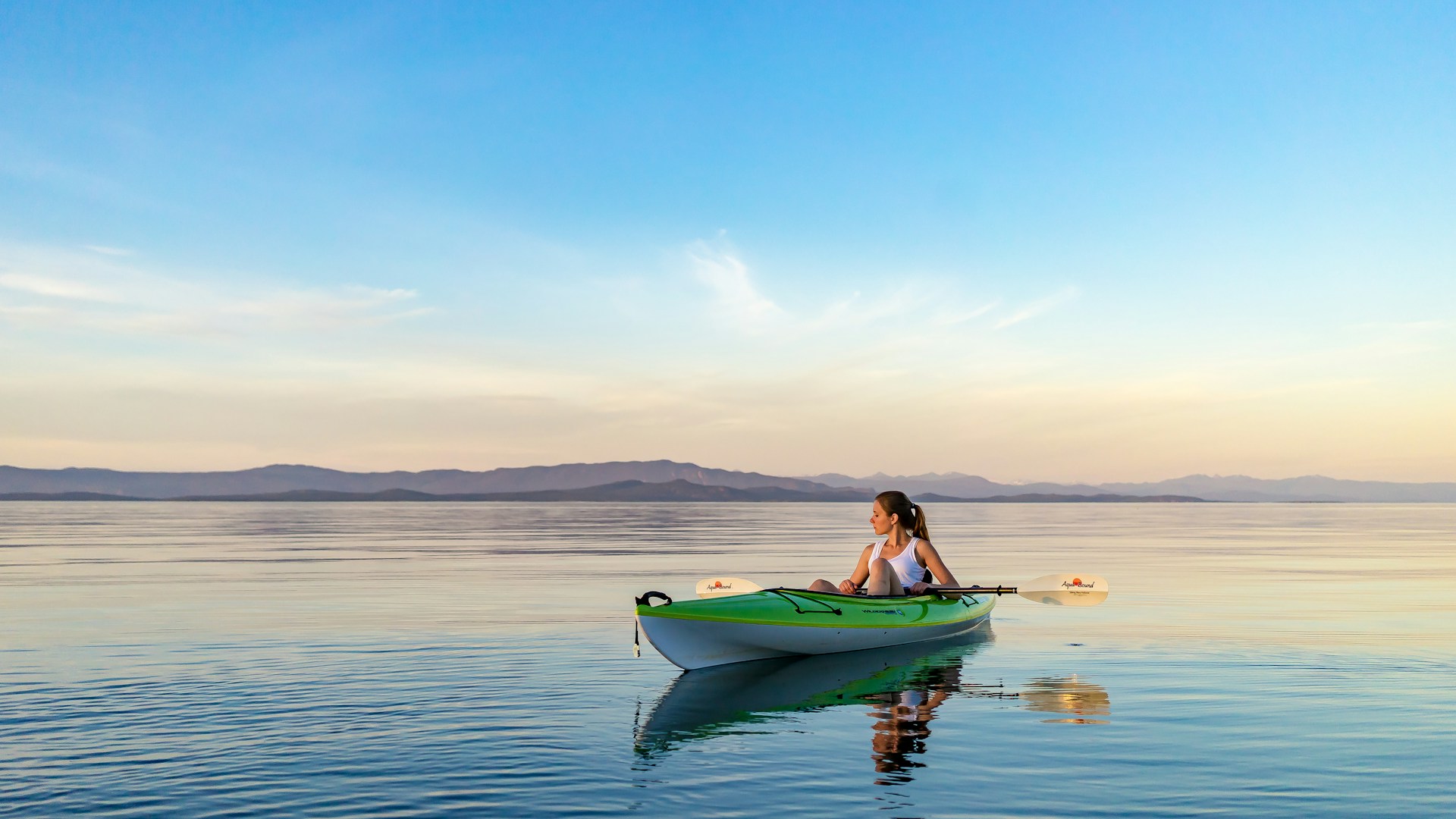 Person kayaking on calm ocean waters near Qualicum Beach