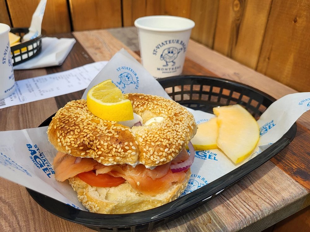 A fresh sesame St-Viateur bagel sliced in half and filled with layers of Montreal smoked meat