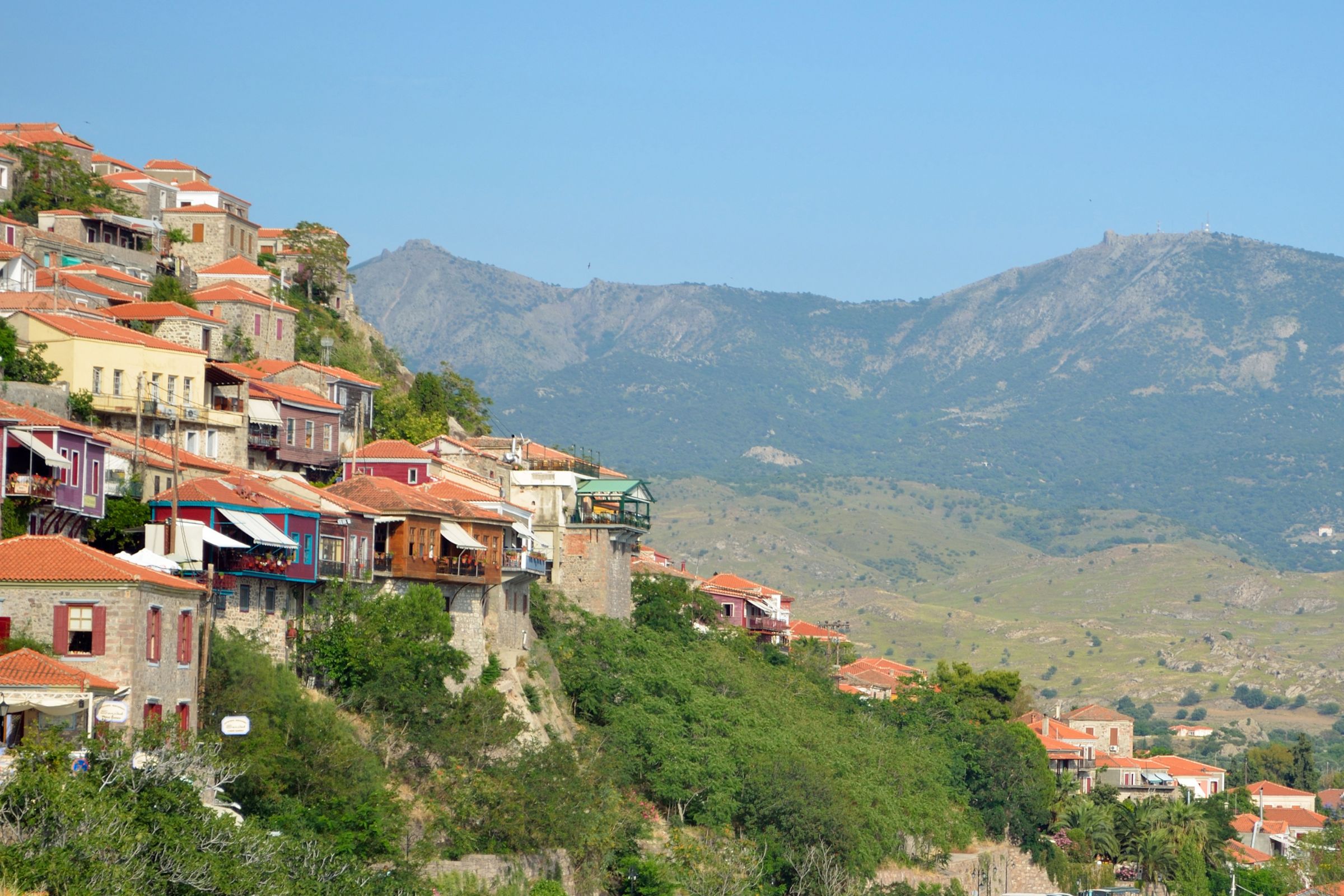 Stone houses march up the hillside Molyvos