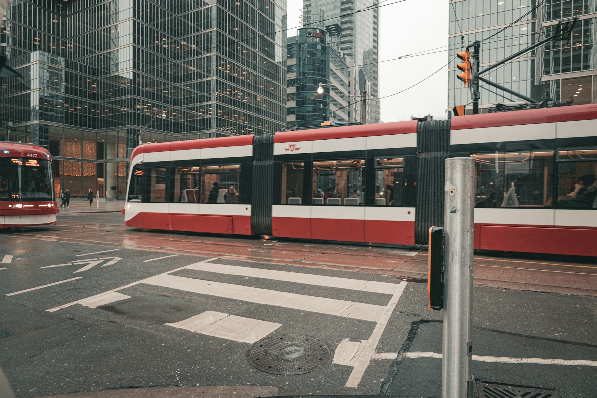 A red and white Toronto streetcar moving through downtown