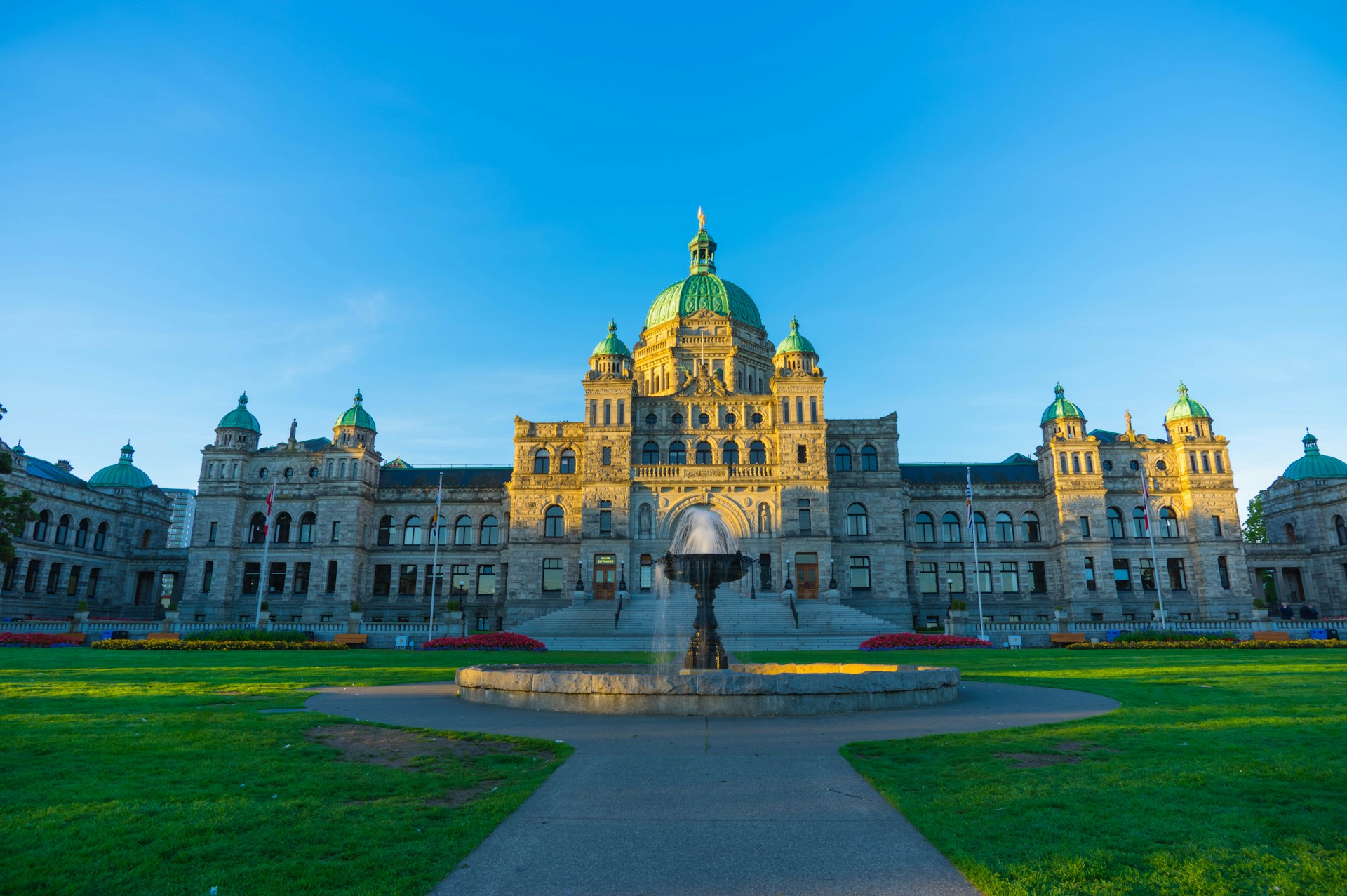 British Columbia Parliament Buildings in Victoria, Canada, with a central green dome and ornate stone facade.