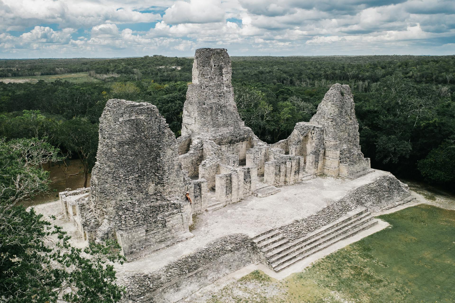 Ancient Mayan ruins surrounded by lush green jungle in the Yucatán Peninsula.