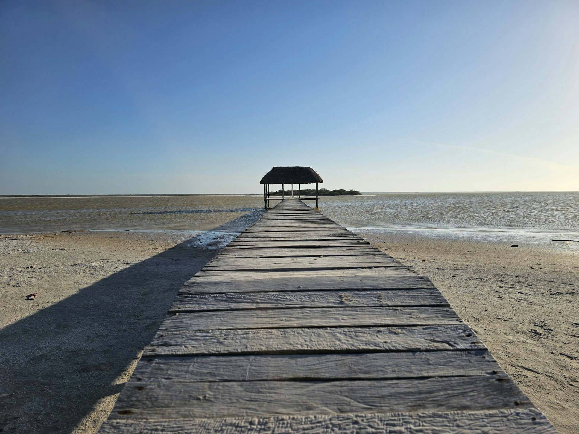 Beautiful Yucatán Peninsula beach with powdery white sand, crystal-clear waters, and lush tropical vegetation along the shoreline.