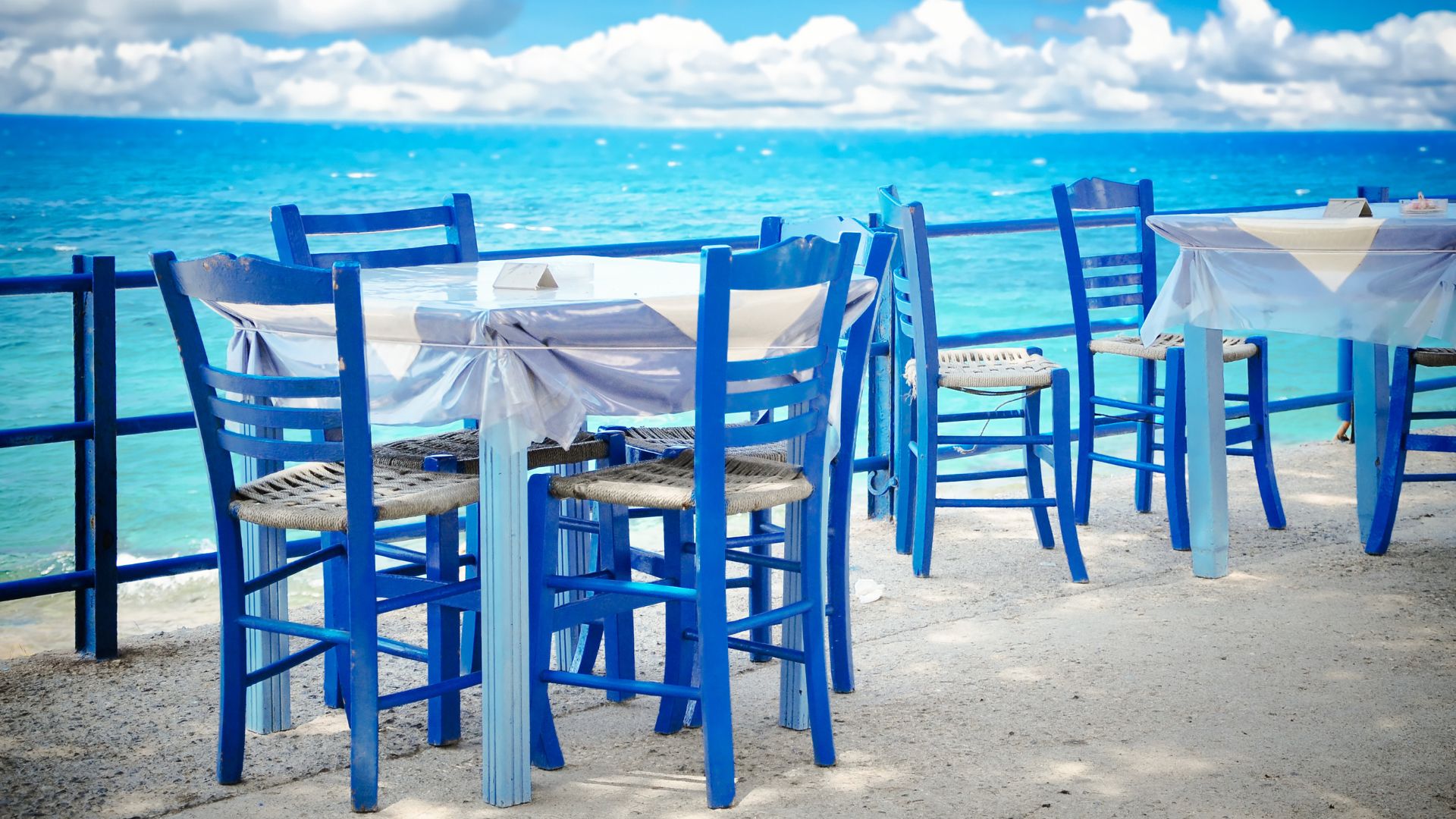 Tables and chairs at beachfront Island taverns.