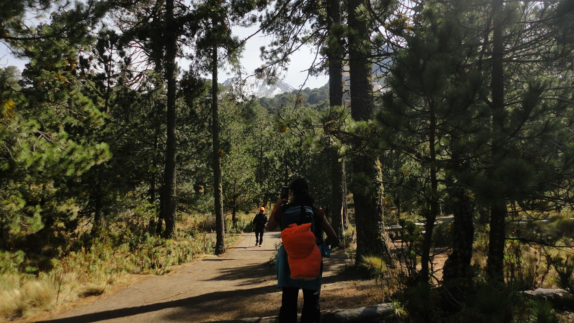 Hiker standing on a rocky trail near the summit of La Malinche volcano
