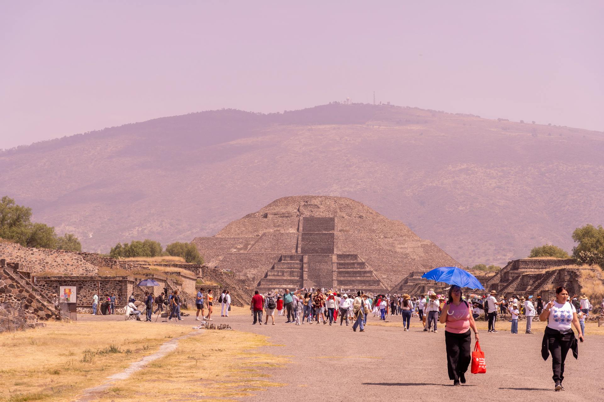 Tourists walking along the Avenue of the Dead at Teotihuacan