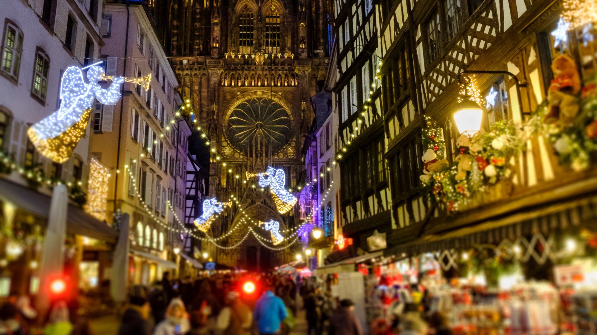 A street in Strasbourg, France, decorated with Christmas lights and leading to the Strasbourg Cathedral at night.