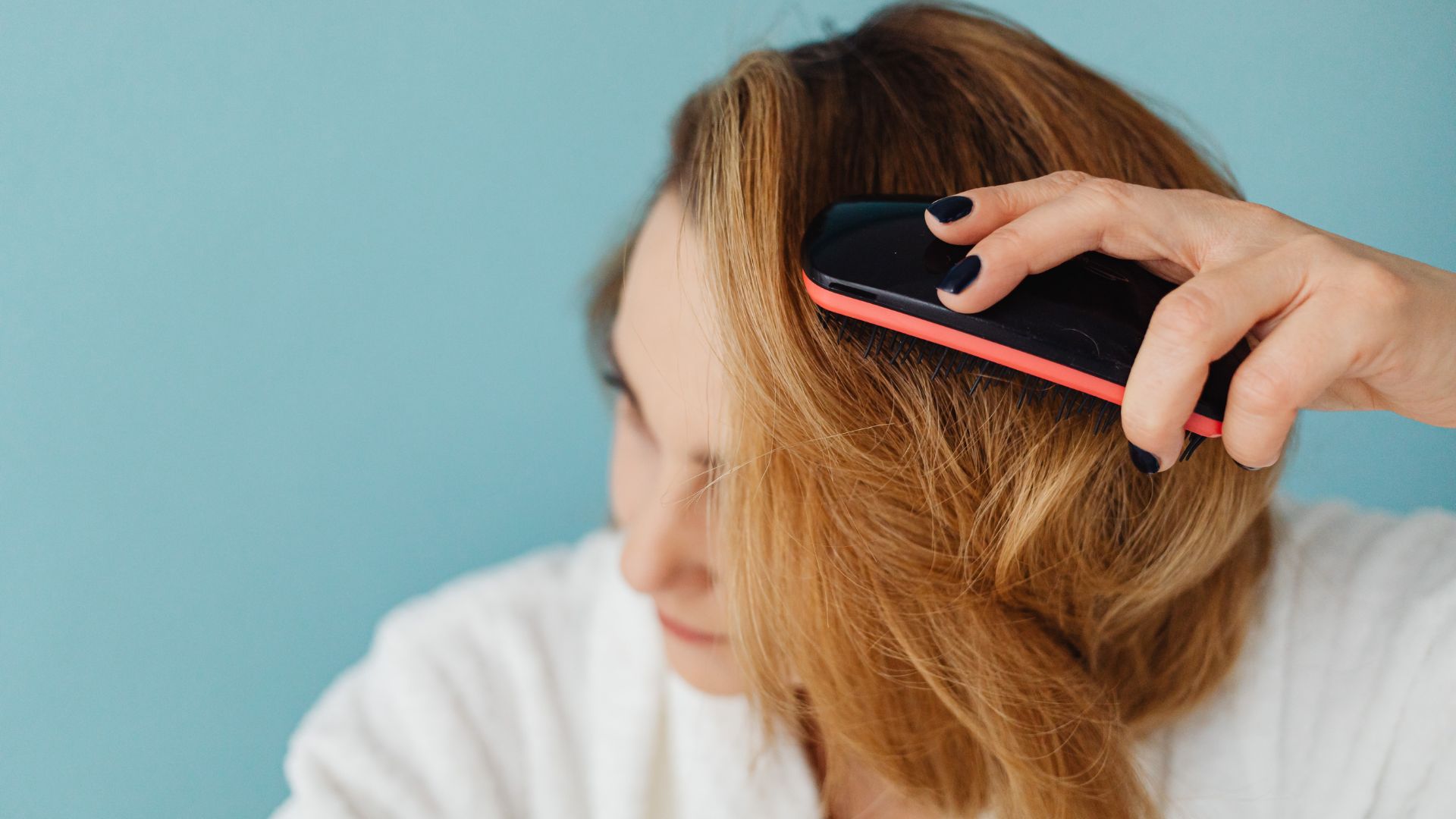 A woman dry brushing before a shower