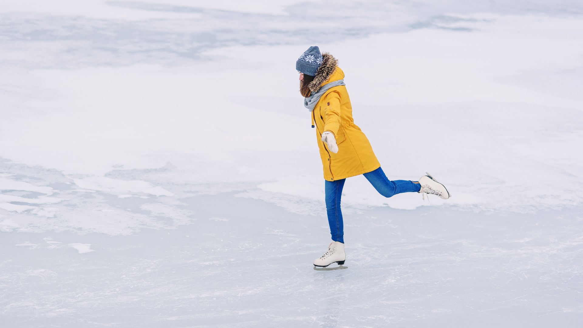 A woman skating in a frozen lake