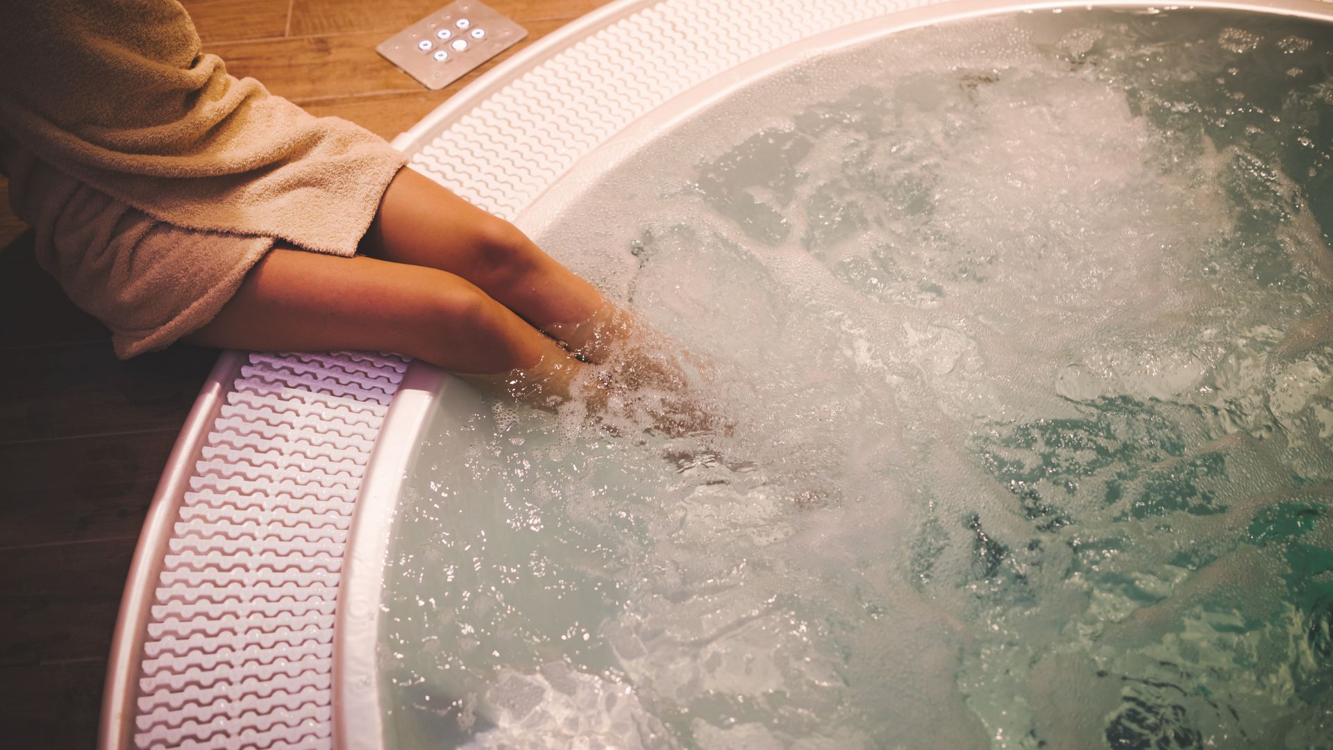 A woman soaking her feet in the Jacuzzi