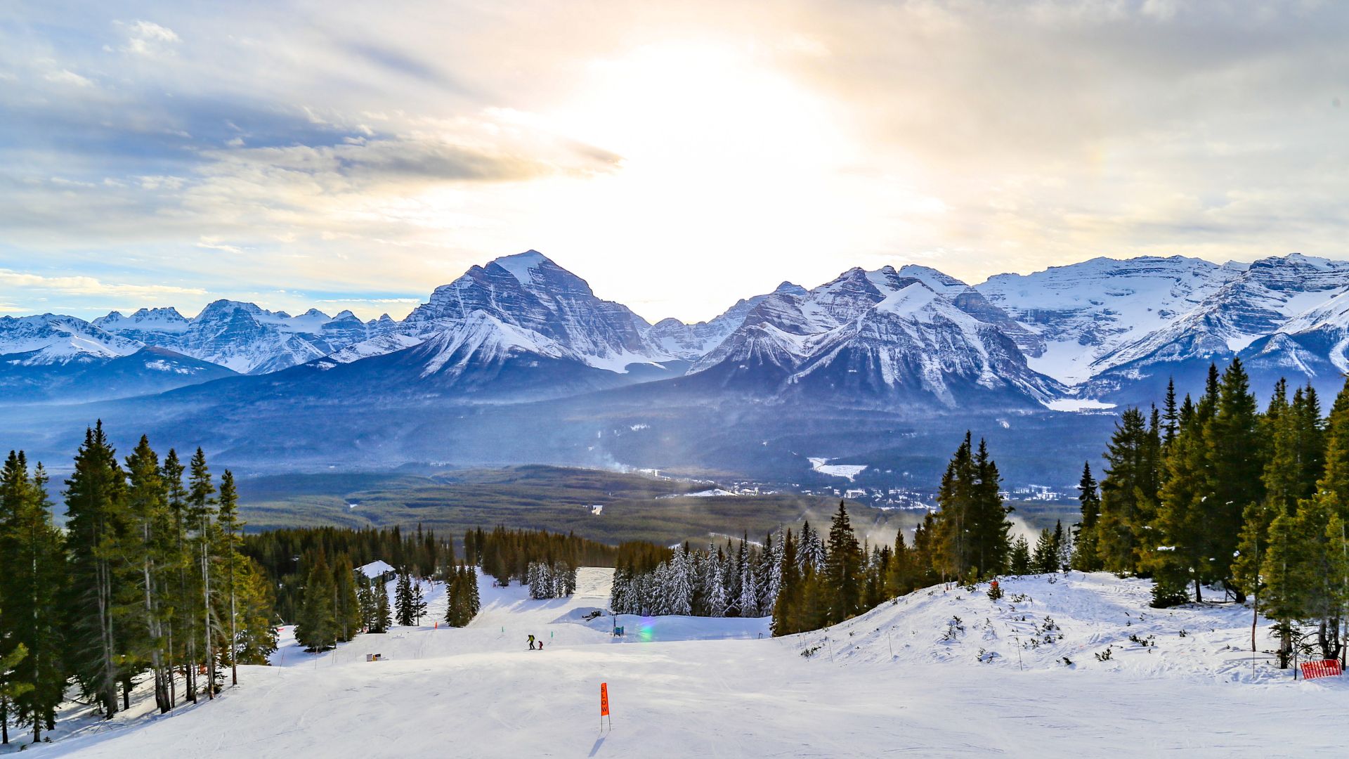 A view of the snowy mountains and ski slopes at the Lake Louise Ski Resort in Canada.
