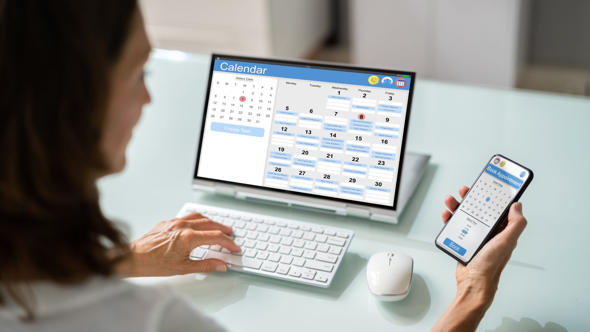 A woman with a laptop and phone, booking a travel.