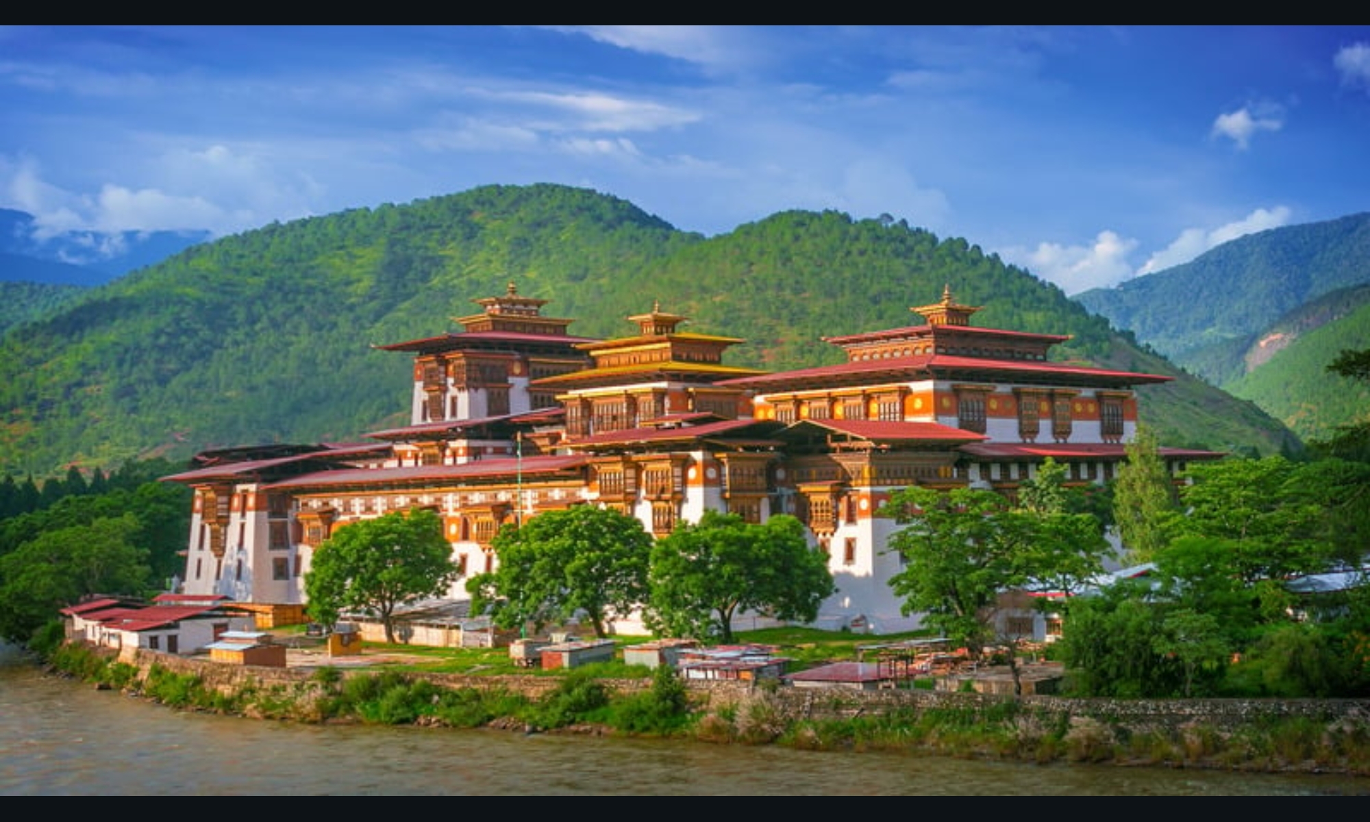 Magnificent traditional Bhutanese architecture with massive, whitewashed, inward-sloping walls, large courtyards, and elaborate woodwork, all built without the use of blueprints or nails in traditional fashion.